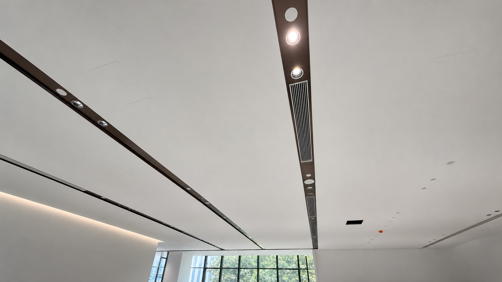 Slot diffuser and recessed spotlights sharing one dark beam